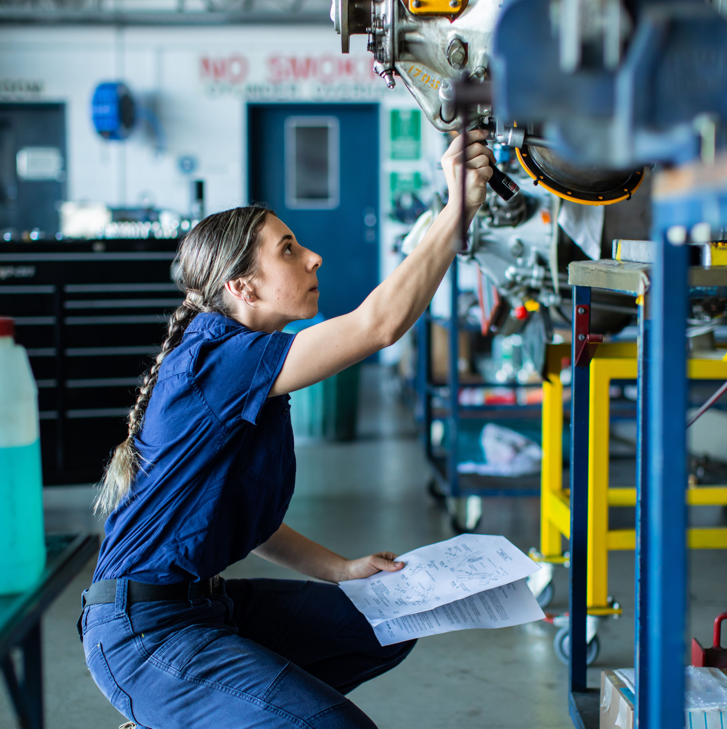 Real life young female aircraft engineer apprentice at work